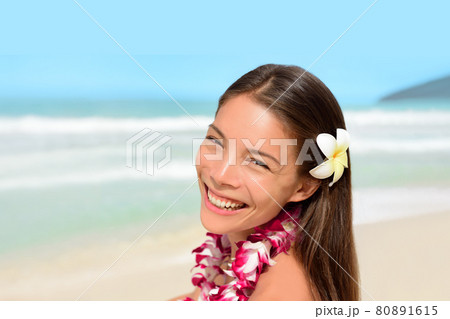 Hawaii luau hula dancer woman happy wearing flower lei on vacation beach travel tropical honeymoon destination. Smiling Asian girl. Hawaii luau hula dancer woman happy wearing flower lei on vacation beach travel tropical honeymoon destination. Smiling Asian girl. 80891615