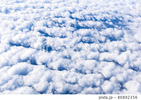 Blue sky with white clouds background with copy space for text, sky wallpaper. View from the plane window 80892356