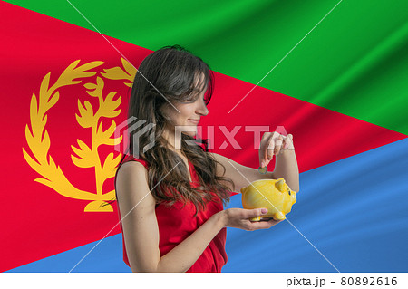 Economy in Eritrea Accumulating and saving money in Eritrea Woman putting money coin in piggy bank for saving money and plan finance Economy in Eritrea Accumulating and saving money in Eritrea Woman putting money coin in piggy bank for saving money and plan finance 80892616