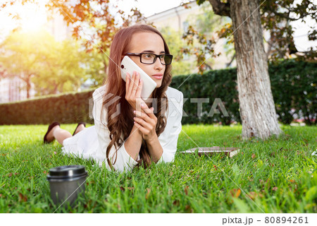 woman in the park with phone 80894261