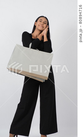 Love Shopping concept. Beautiful Asian woman carrying gray color bags shopping online. isolated on white studio background. online shopping bag. black hair woman love shopping online. Online purchase 80894716