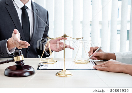 A male lawyer or a judge counseling clients about judicial justice and prosecution with scales, judges gavel, legal documents legal services concept A male lawyer or a judge counseling clients about judicial justice and prosecution with scales, judges gavel, legal documents legal services concept 80895936