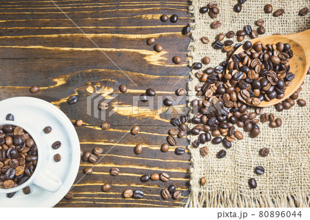 Cup with coffee beans on rustic background 80896044