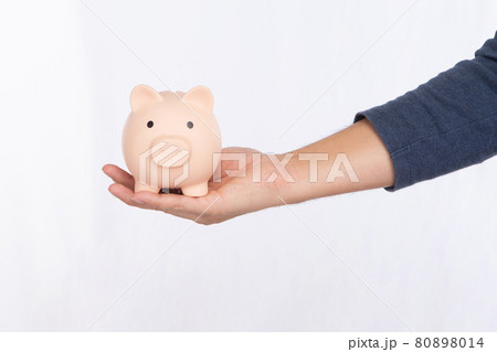 Hand holding a pink piggy bank isolated on white background 80898014