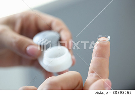 New clear contact lens on finger closeup New clear contact lens on finger closeup 80898565