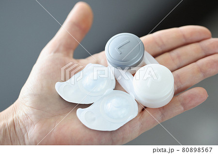 Container with new contact eye lenses on arm closeup Container with new contact eye lenses on arm closeup 80898567