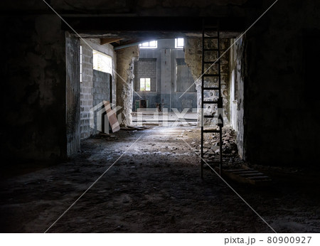 Abandoned industrial interior with rubble on floor, broken glass and wooden stairs 80900927
