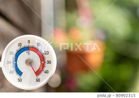 Outdoor thermometer shows extreme hot summer temperature 80902315