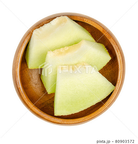 Galia melon slices, in a wooden bowl. Triangular and ready-to-eat pieces of a freshly cut and ripe fruit of Cucumis melo var. reticulatus, a sweet and aromatic hybrid melon, also known as sarda. Photo Galia melon slices, in a wooden bowl. Triangular and ready-to-eat pieces of a freshly cut and ripe fruit of Cucumis melo var. reticulatus, a sweet and aromatic hybrid melon, also known as sarda. Photo 80903572