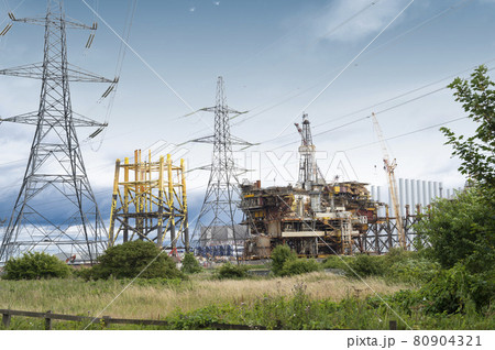 Seaton, Devon, U.K. July, 30,2021. Offshore oil platform with a supply vessel on the North Sea 80904321