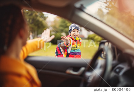 Mother dropped off her little cute child near the school Mother dropped off her little cute child near the school 80904406