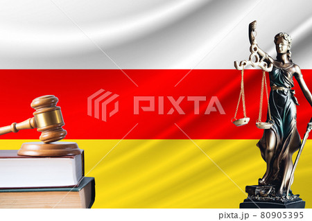 Law and justice in South Ossetia. Statue of themis and the gavel of the judge against the background of the flag of South Ossetia. Law and justice concept Law and justice in South Ossetia. Statue of themis and the gavel of the judge against the background of the flag of South Ossetia. Law and justice concept 80905395