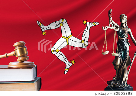 Law and justice in Isle of Man. Statue of themis and the gavel of the judge against the background of the flag of Isle of Man. Law and justice concept 80905398
