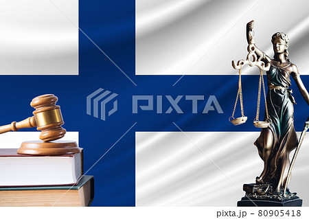 Law and justice in Finland. Statue of themis and the gavel of the judge against the background of the flag of Finland. Law and justice concept Law and justice in Finland. Statue of themis and the gavel of the judge against the background of the flag of Finland. Law and justice concept 80905418