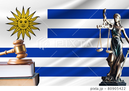 Law and justice in Uruguay. Statue of themis and the gavel of the judge against the background of the flag of Uruguay. Law and justice concept 80905422
