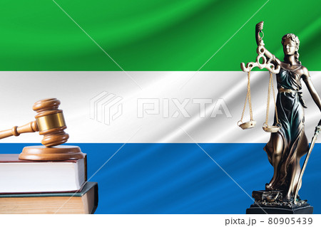 Law and justice in Sierra Leone. Statue of themis and the gavel of the judge against the background of the flag of Sierra Leone. Law and justice concept 80905439