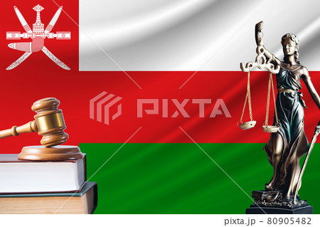 Law and justice in Oman. Statue of themis and the gavel of the judge against the background of the flag of Oman. Law and justice concept Law and justice in Oman. Statue of themis and the gavel of the judge against the background of the flag of Oman. Law and justice concept 80905482