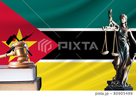 Law and justice in Mozambique. Statue of themis and the gavel of the judge against the background of the flag of Mozambique. Law and justice concept 80905499
