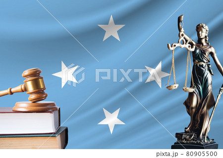 Law and justice in Federated States of Micronesia. Statue of themis and the gavel of the judge against the background of the flag of Federated States of Micronesia. Law and justice concept 80905500