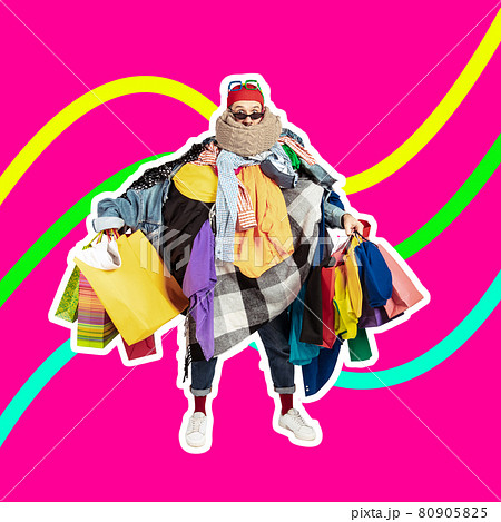 Sales concept. One young man dressed in many bright clothes holding a lot of paper bags. Black friday, fashion, ad concept 80905825