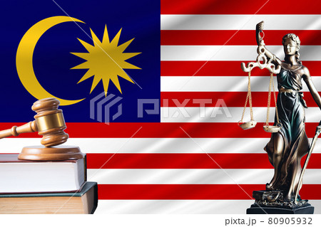 Law and justice in Malaysia. Statue of themis and the gavel of the judge against the background of the flag of Malaysia. Law and justice concept 80905932