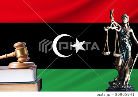 Law and justice in Libya. Statue of themis and the gavel of the judge against the background of the flag of Libya. Law and justice concept Law and justice in Libya. Statue of themis and the gavel of the judge against the background of the flag of Libya. Law and justice concept 80905941