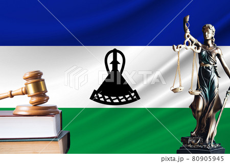 Law and justice in Lesotho Statue of themis and the gavel of the judge against the background of the flag of Lesotho Law and justice concept 80905945