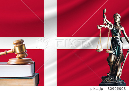 Law and justice in Denmark. Statue of themis and the gavel of the judge against the background of the flag of Denmark. Law and justice concept 80906008