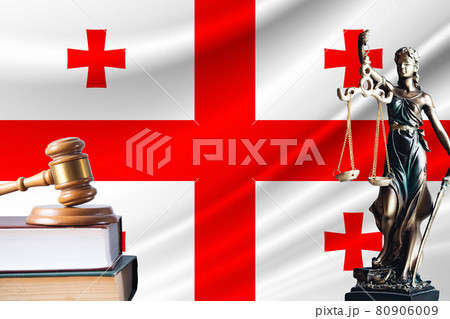 Law and justice in Georgia. Statue of themis and the gavel of the judge against the background of the flag of Georgia. Law and justice concept 80906009