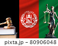 Law and justice in Afghanistan. Statue of themis and the gavel of the judge against the background of the flag of Afghanistan. Law and justice concept 80906048