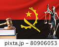 Law and justice in Angola. Statue of themis and the gavel of the judge against the background of the flag of Angola. Law and justice concept 80906053