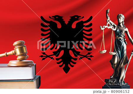Law and justice in Albania. Statue of themis and the gavel of the judge against the background of the flag of Albania. Law and justice concept 80906152