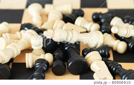 Heap of chess pieces on chess board top view Heap of chess pieces on chess board top view 80906910