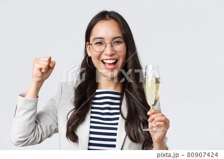Business, finance and employment, female successful entrepreneurs concept. Happy asian businesswoman celebrating, having office party, drinking champagne, chanting from rejoice, triumphing Business, finance and employment, female successful entrepreneurs concept. Happy asian businesswoman celebrating, having office party, drinking champagne, chanting from rejoice, triumphing 80907424
