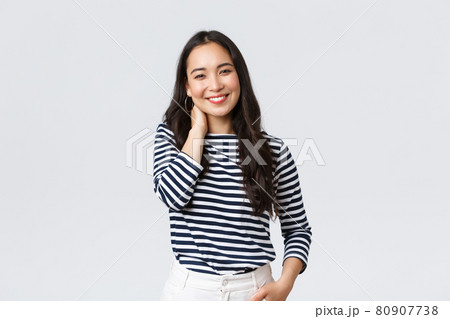 Lifestyle, people emotions and casual concept. Joyful beautiful asian woman in stylish casual clothes, touch neck blushing and smiling, having small talk at romantic date 80907738