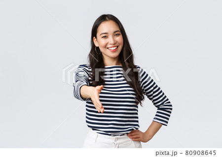 Lifestyle, people emotions and casual concept. Friendly outgoing asian woman extend hand for handshake, have business meeting, say nice to meet you, greet new people in company 80908645