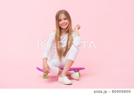 Enjoying vibes on penny board. Cute little child sitting Enjoying vibes on penny board. Cute little child sitting 80909809
