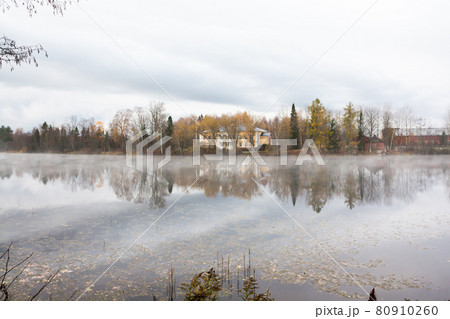 KOUVOLA, FINLAND - OCTOBER 23, 2018: Beautiful wooden Rabbelugn Manor - Takamaan Kartano in fog autumn day. Wrede family house was built in 1820 on the river Kymijoki bank KOUVOLA, FINLAND - OCTOBER 23, 2018: Beautiful wooden Rabbelugn Manor - Takamaan Kartano in fog autumn day. Wrede family house was built in 1820 on the river Kymijoki bank 80910260