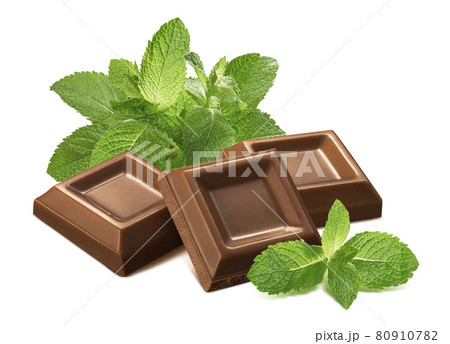Fresh mint leaves and chocolate pieces isolated on white background Fresh mint leaves and chocolate pieces isolated on white background 80910782