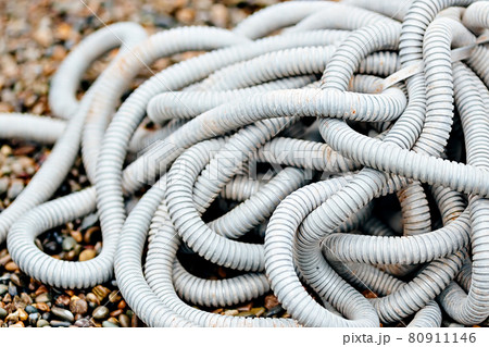 Plastic corrugated hose for insulation of wires lies on the crushed stone. Plastic corrugated hose for insulation of wires lies on the crushed stone. 80911146