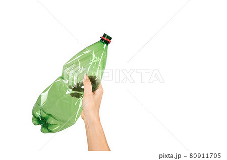Close-up of a female hand holding a green plastic bottle on a white background. Isolated Close-up of a female hand holding a green plastic bottle on a white background. Isolated 80911705