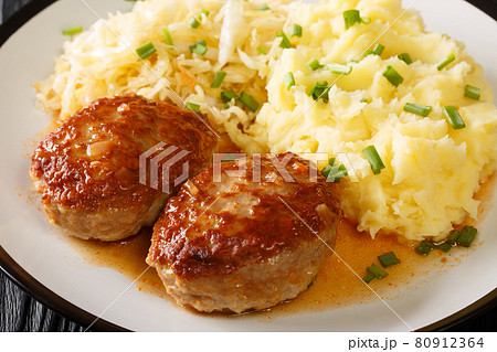 Tasty menu Norwegian pork meatballs Medisterkaker served with mashed potatoes and sauerkraut close-up in a plate. horizontal 80912364