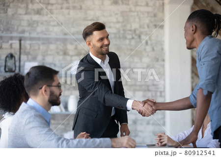 Smiling diverse businesspeople handshake at office meeting 80912541