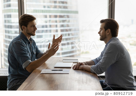 Two businessmen, business partners meeting in office for negotiation 80912719
