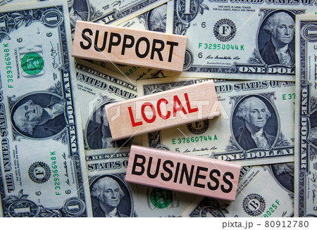 Concept text 'support local business' on wooden blocks on a beautiful background from dollar bills. Business and covid-19 pandemic concept. 80912780