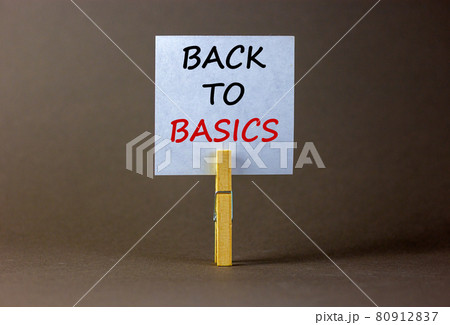 White paper with text 'back to basics', clip on wood clothespin. Beautiful grey background. Business concept. Copy space. 80912837