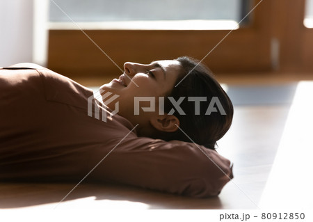 Calm Indian woman relax on floor at home napping Calm Indian woman relax on floor at home napping 80912850