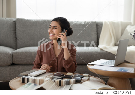 Smiling Indian woman choose block samples for home decoration 80912951