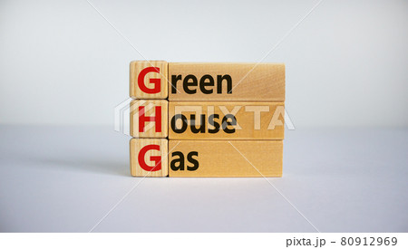 Greenhouse gas symbol. Concept words 'GHG, greenhouse gas' on cubes and blocks on a beautiful white background. Business and GHG concept. Copy space. 80912969
