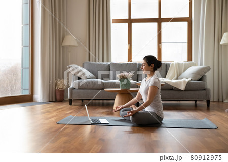 Calm Indian woman practice yoga on webcam call at home Calm Indian woman practice yoga on webcam call at home 80912975